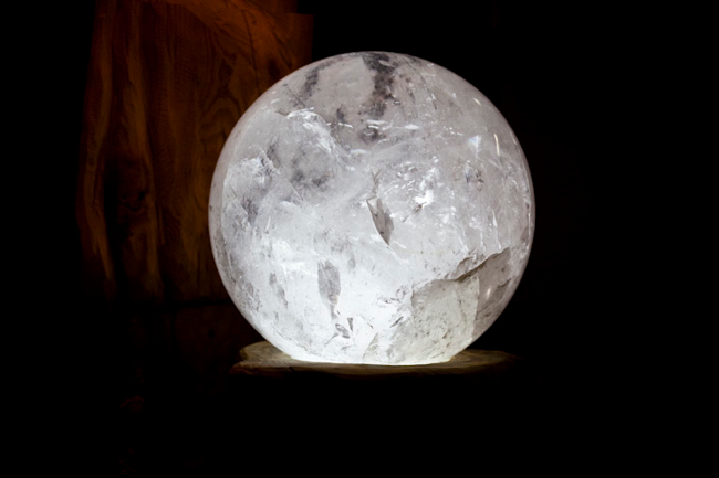 Large quartz sphere.  Brazil.  Petrified wood stand.  Indonesia